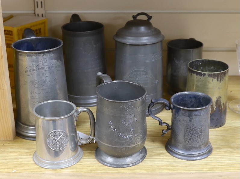 Seven pewter tankards relating to shooting clubs and artillery volunteers, and a smaller similar silver plated mug, tallest 21cm